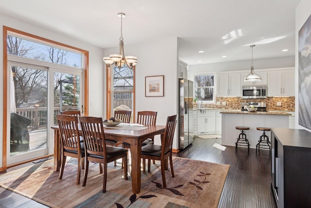 2536 Saunders Lake Dr, Minnetrista, MN 55364 - dining area featuring a chandelier, dark wood-style flooring, and recessed lighting