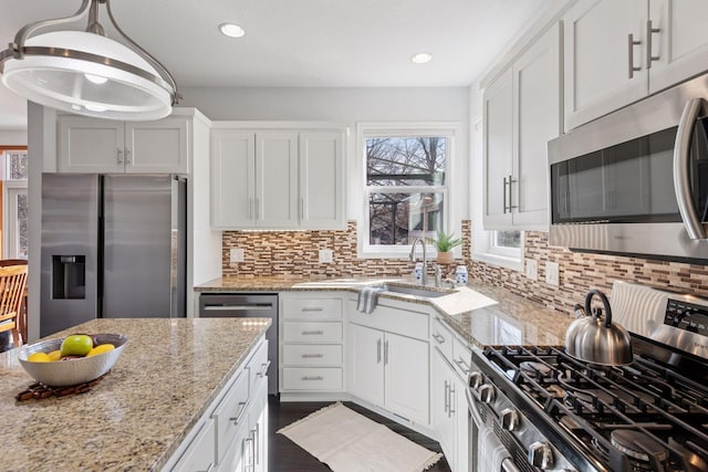 2536 Saunders Lake Dr, Minnetrista, MN 55364 - kitchen featuring appliances with stainless steel finishes, plenty of natural light, tasteful backsplash, white cabinets, and recessed lighting