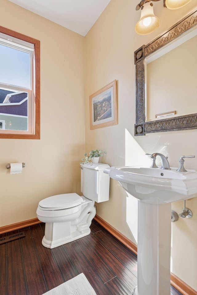 2536 Saunders Lake Dr, Minnetrista, MN 55364 - half bath with baseboards, toilet, and wood finished floors