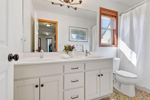 2536 Saunders Lake Dr, Minnetrista, MN 55364 - bathroom featuring double vanity, toilet, a chandelier, and tile patterned flooring