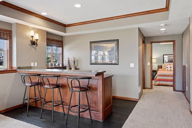 2536 Saunders Lake Dr, Minnetrista, MN 55364 - indoor wet bar with ornamental molding, baseboards, recessed lighting, a raised ceiling, and dark wood finished floors