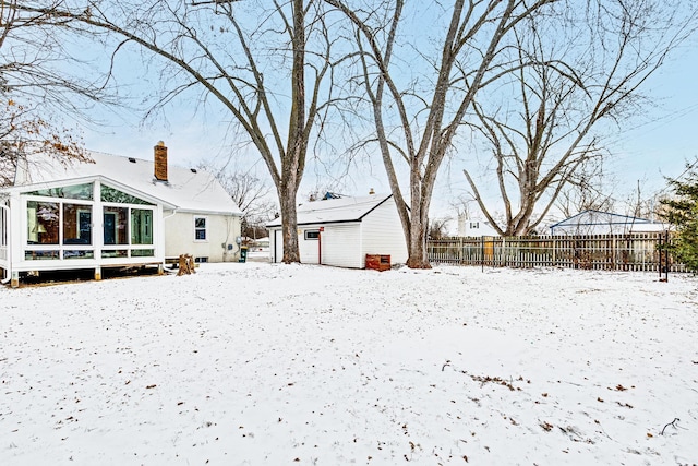 view of snow covered back of property