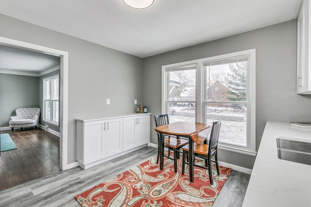 dining area with hardwood / wood-style flooring and sink