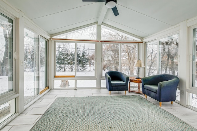 sunroom with ceiling fan and lofted ceiling with beams