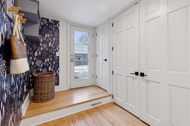 doorway to outside featuring light wood finished floors and visible vents