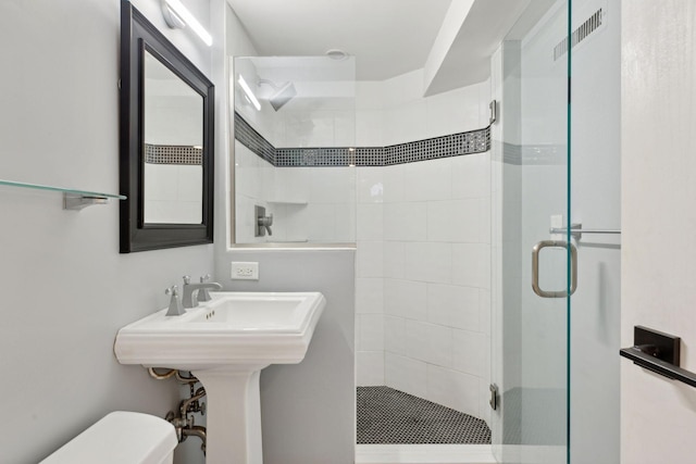 bathroom featuring a stall shower, visible vents, and toilet