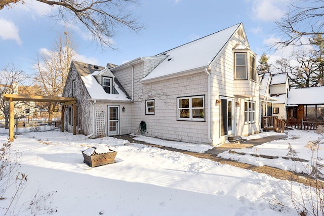 view of snow covered back of property