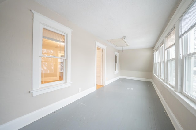 spare room featuring hardwood / wood-style floors and a textured ceiling