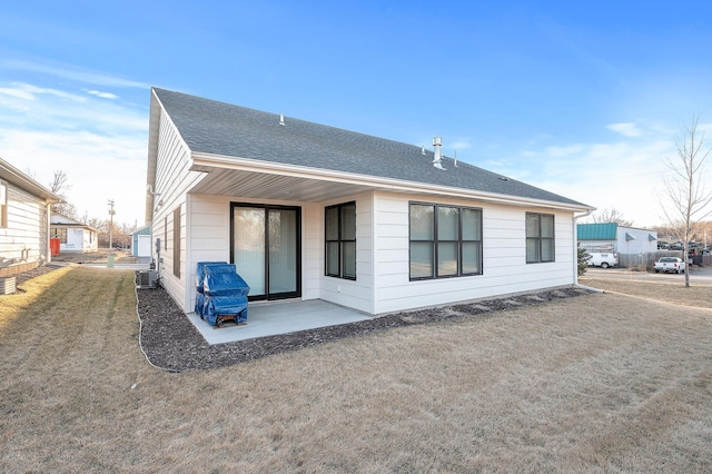 rear view of house with a patio, a yard, and cooling unit