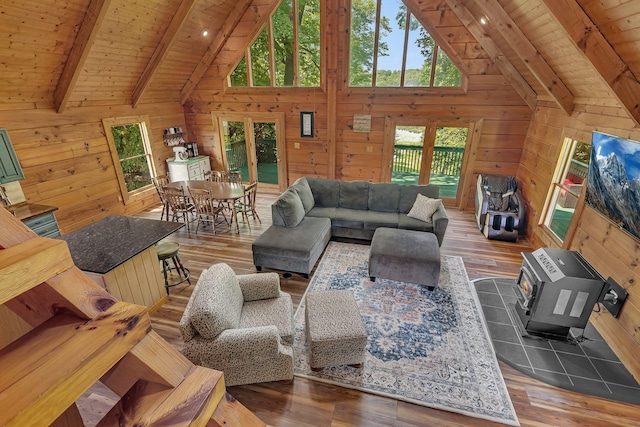 living room featuring beam ceiling, wood ceiling, and wooden walls