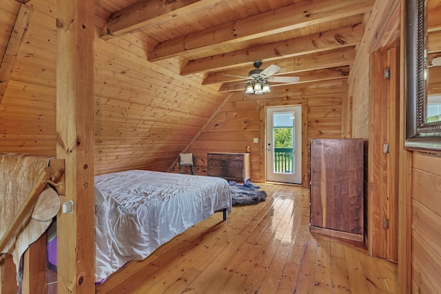 bedroom with vaulted ceiling with beams, wood walls, wood ceiling, and light hardwood / wood-style flooring