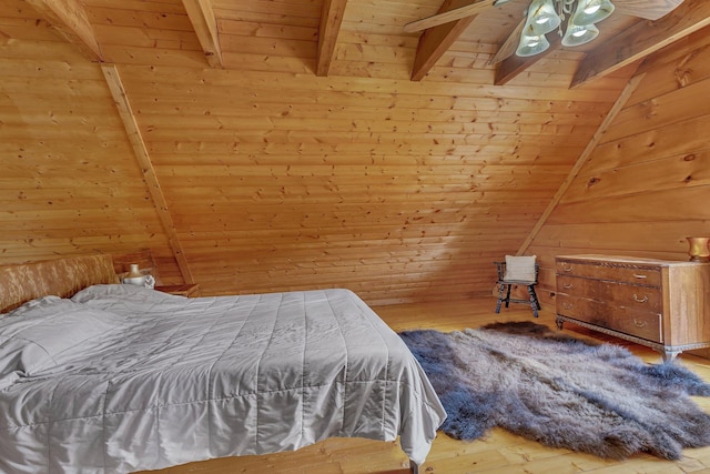 bedroom with hardwood / wood-style flooring, lofted ceiling with beams, wood ceiling, and wood walls