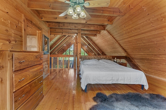 unfurnished bedroom featuring wood ceiling, wooden walls, light hardwood / wood-style flooring, and vaulted ceiling with beams