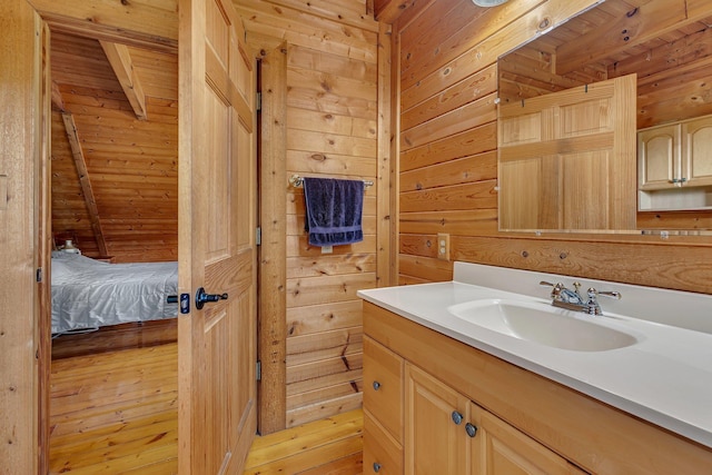 bathroom with vanity and wood walls