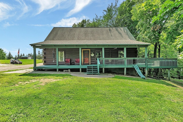 log cabin with a front lawn