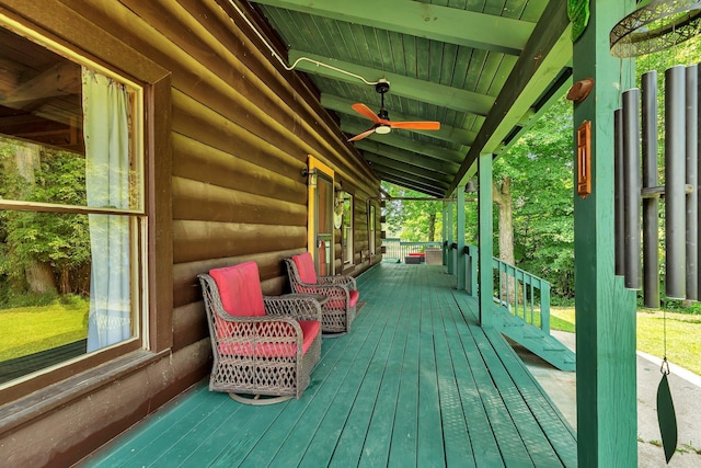 wooden terrace featuring ceiling fan and a porch