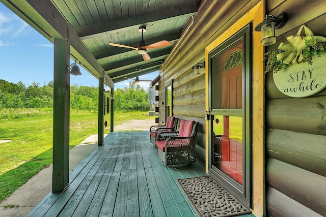 deck featuring ceiling fan, a porch, and a lawn