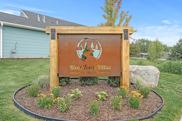 community sign featuring a lawn