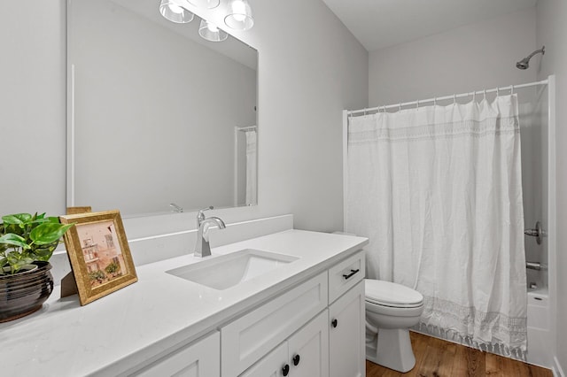 full bathroom featuring vanity, hardwood / wood-style floors, toilet, and shower / bathtub combination with curtain