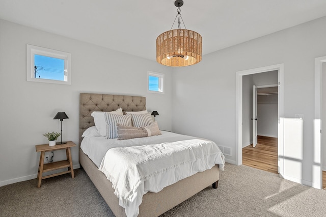 bedroom featuring a chandelier and carpet