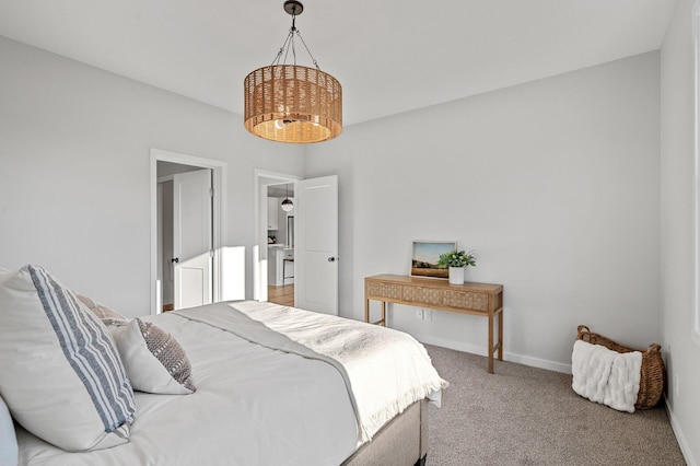 bedroom with carpet flooring and a notable chandelier