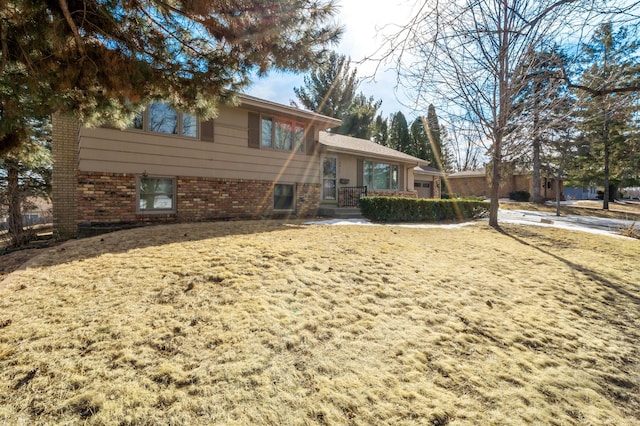 tri-level home featuring brick siding