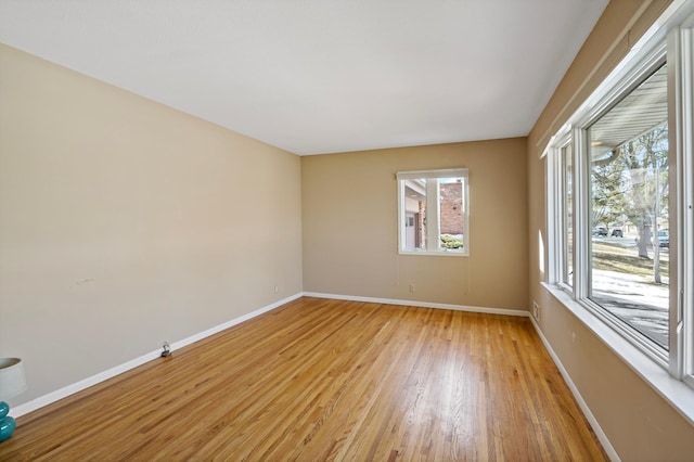 empty room featuring light wood-style floors and baseboards