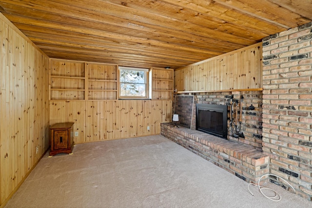 unfurnished living room with wooden walls, carpet flooring, and wood ceiling