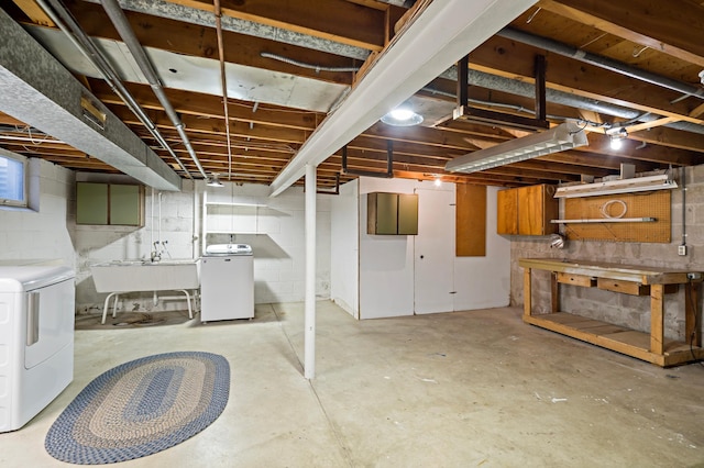 unfinished basement with washing machine and dryer and a sink