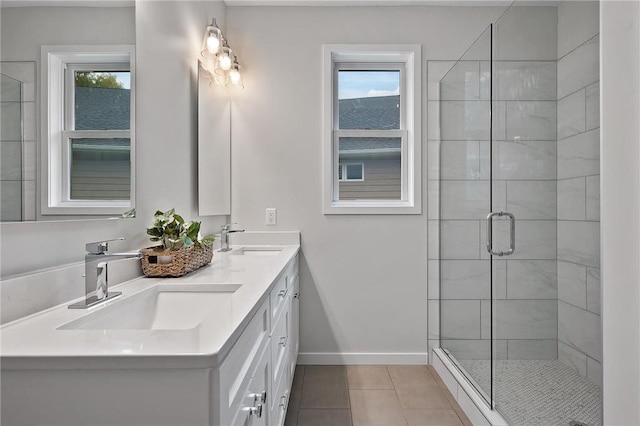 bathroom with walk in shower, vanity, tile patterned flooring, and a wealth of natural light