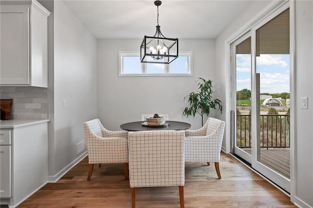 dining room with an inviting chandelier and light wood-type flooring