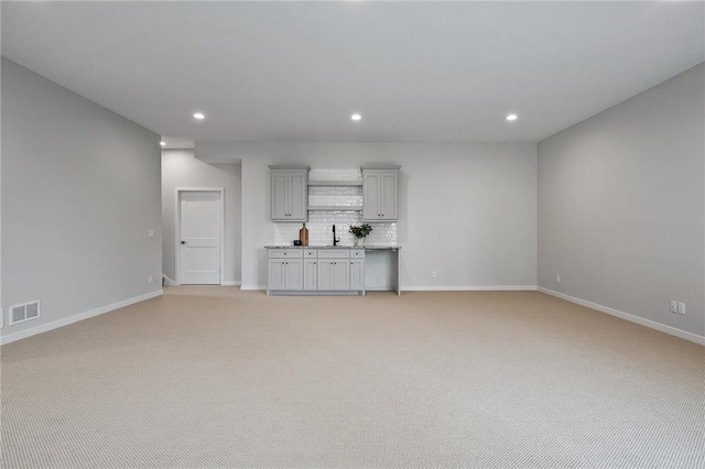 unfurnished living room with light colored carpet