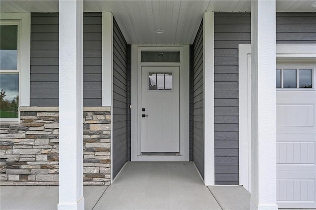 view of exterior entry with a garage