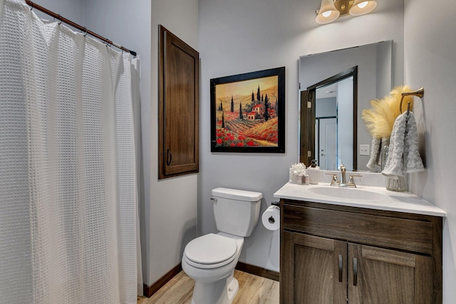 bathroom with hardwood / wood-style flooring, vanity, and toilet