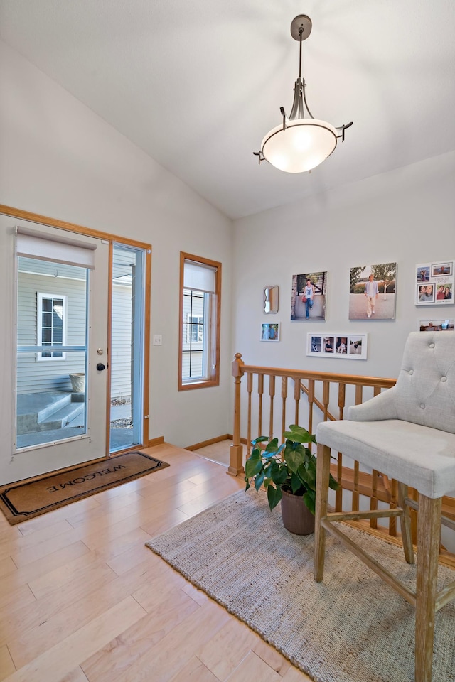 foyer featuring lofted ceiling and light hardwood / wood-style flooring