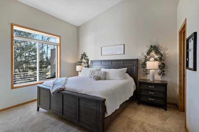 bedroom featuring vaulted ceiling and light carpet