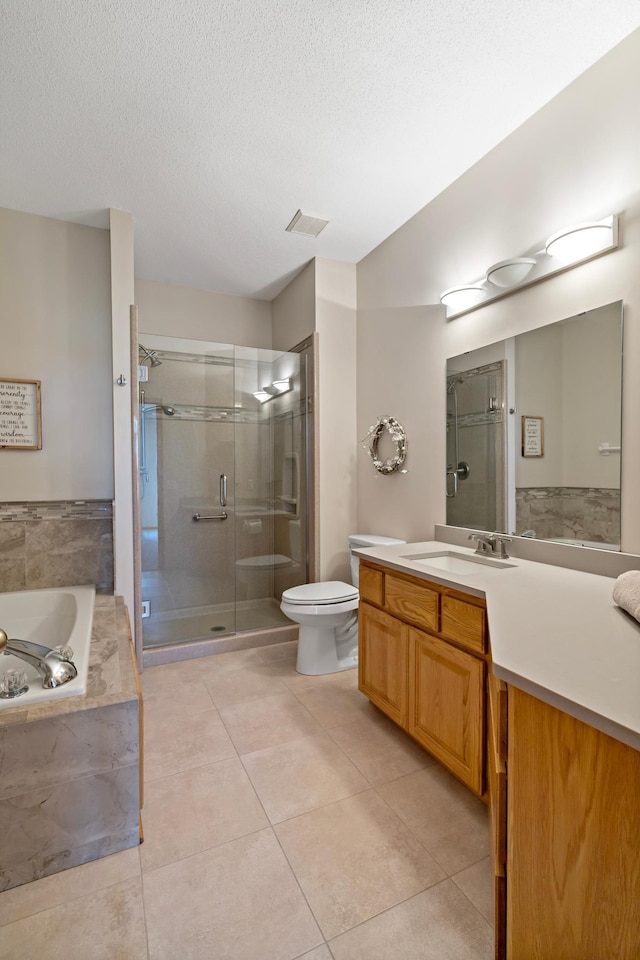 full bathroom with tile patterned floors, toilet, a textured ceiling, vanity, and plus walk in shower