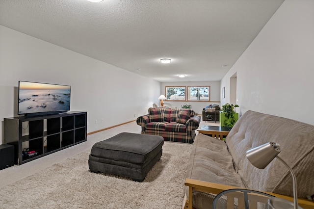 living room featuring carpet floors and a textured ceiling