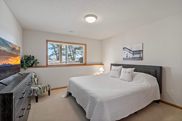 carpeted bedroom featuring a textured ceiling