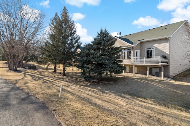 view of front of house featuring central AC and a front lawn