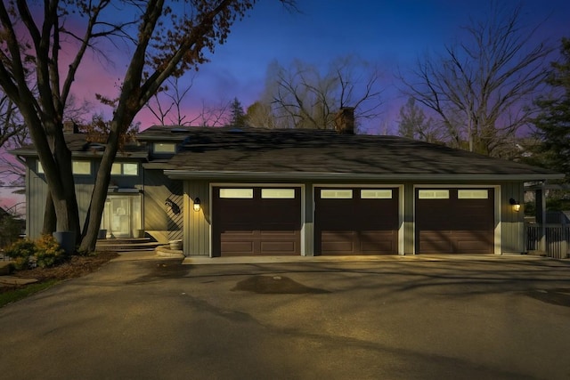 7720 Shaughnessy Rd, Edina, MN 55439 - view of front facade featuring a chimney, board and batten siding, and a detached garage
