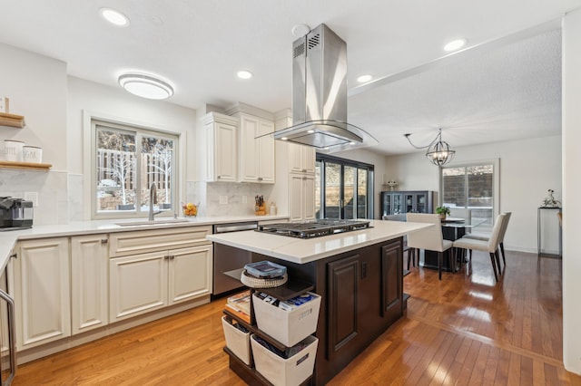 7720 Shaughnessy Rd, Edina, MN 55439 - kitchen featuring open shelves, island range hood, dishwasher, gas stovetop, and healthy amount of natural light