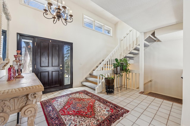 7720 Shaughnessy Rd, Edina, MN 55439 - foyer entrance with tile patterned flooring, a chandelier, a towering ceiling, and stairway