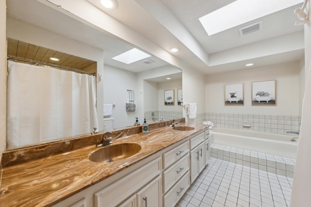 7720 Shaughnessy Rd, Edina, MN 55439 - bathroom featuring a skylight, tile patterned flooring, double vanity, a garden tub, and recessed lighting