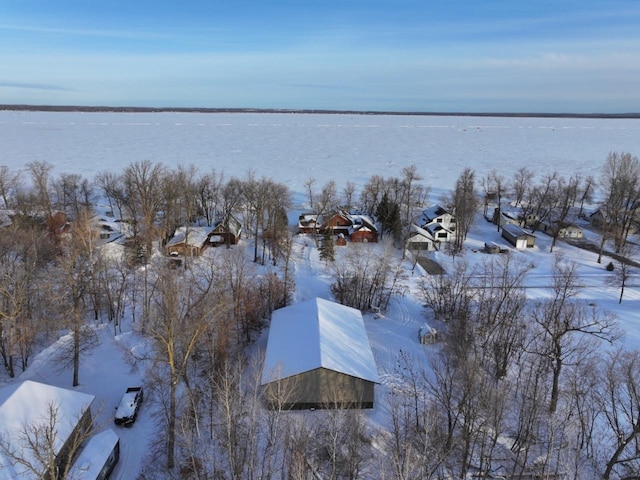 snowy aerial view featuring a water view