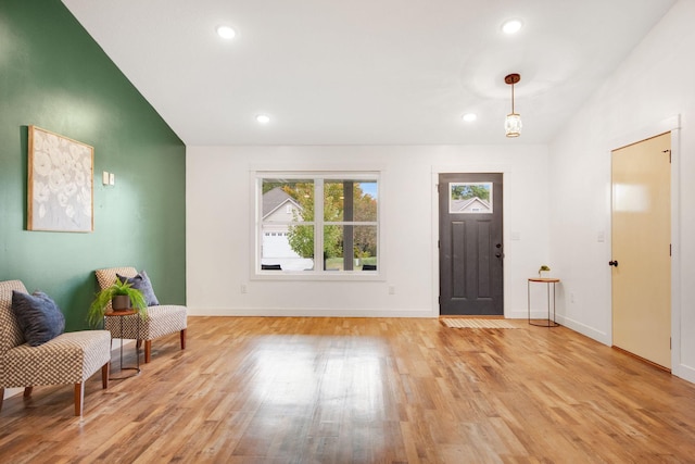 entrance foyer featuring lofted ceiling and light hardwood / wood-style floors