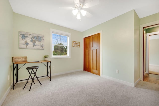 home office with ceiling fan and light colored carpet