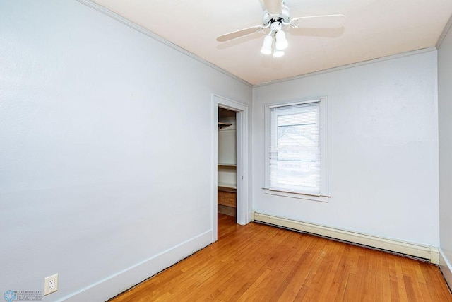 unfurnished room featuring crown molding, a baseboard heating unit, ceiling fan, and light hardwood / wood-style flooring