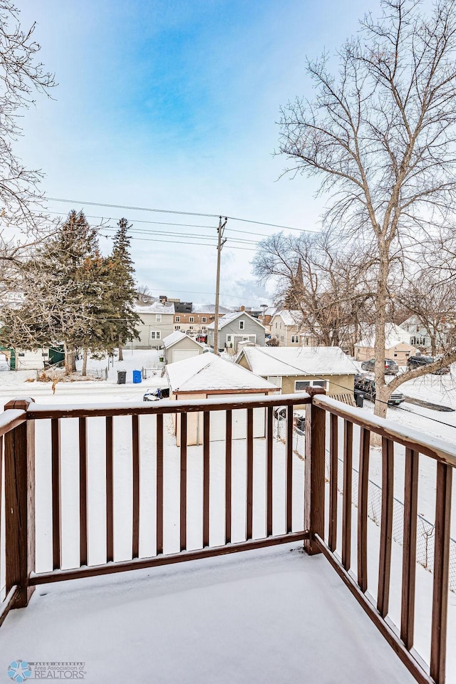 view of snow covered back of property