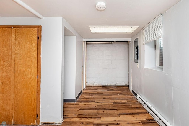 hallway featuring a baseboard radiator and dark hardwood / wood-style flooring